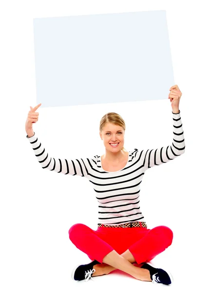 Woman holding banner ad over her head — Stock Photo, Image