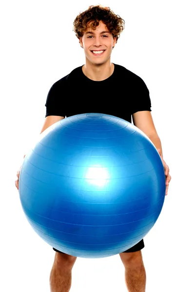 Mann in Sportkleidung hält großen Ball — Stockfoto