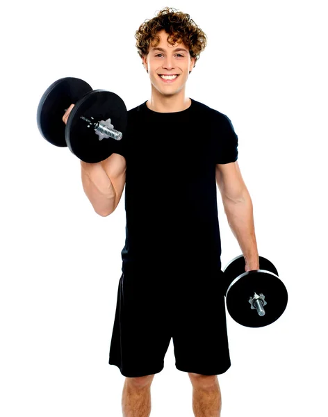 Smiling muscular man doing exercise — Stock Photo, Image