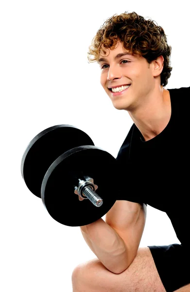 Muscular man in black sportswear with dumbbell — Stock Photo, Image