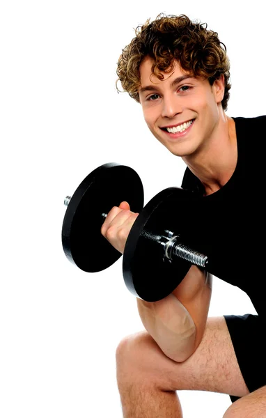 Strong young man working out with dumbbells — Stock Photo, Image