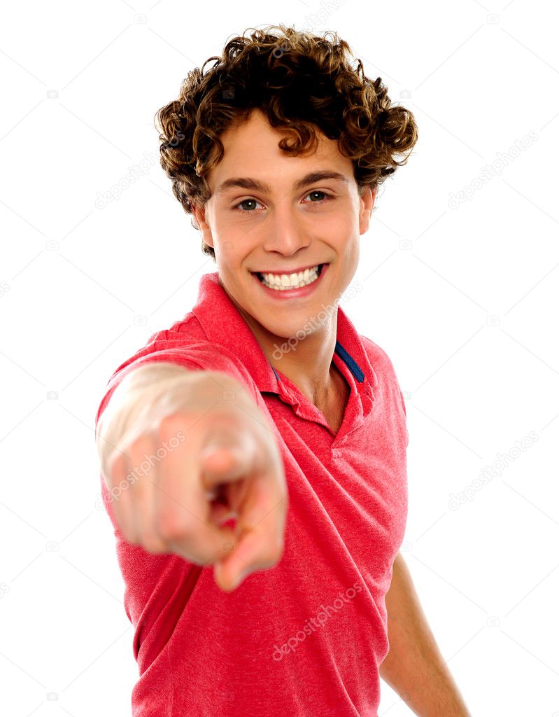Handsome curly hair teen pointing at you