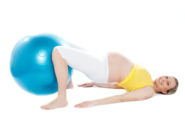 Беременная женщина делает упражнения релаксации — стоковое фото