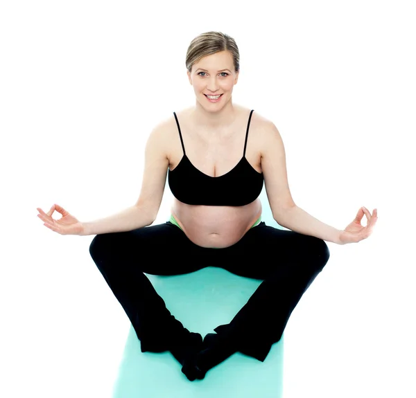 Krásná těhotná žena v lotus pose — Stock fotografie