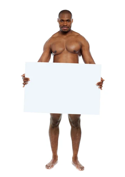 Naked man hiding behind blank white billboard — Stock Photo, Image