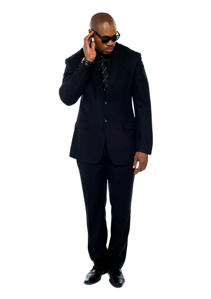 African businessman trying to listen to something — Stock Photo, Image