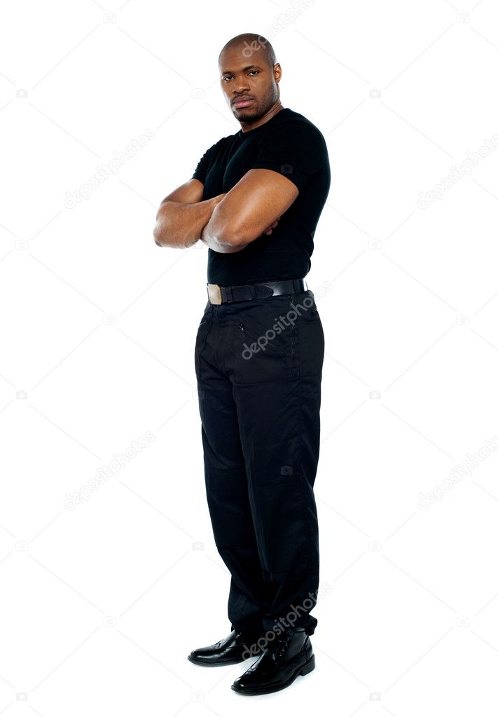 Male security guard with strong arms crossed