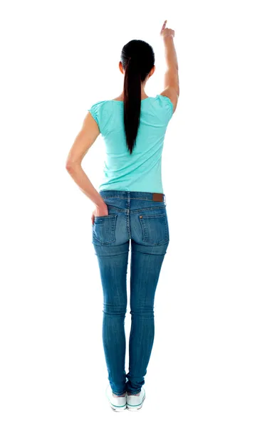 Visão traseira da jovem mulher em baixas, apontando — Fotografia de Stock