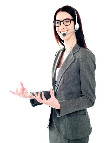 Smiling telemarketing girl posing in headsets — Stock Photo, Image