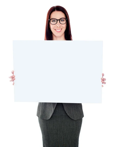 Businesswoman holding a blank poster — Stock Photo, Image