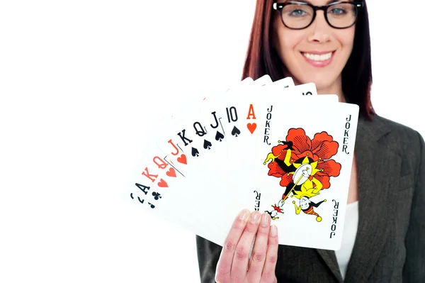 Charming businesswoman holding playing cards — Stock Photo, Image