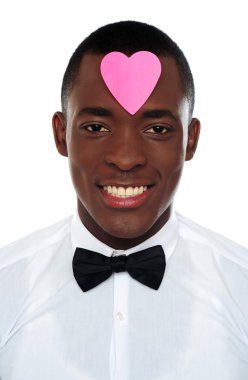 African man with pink paper heart on his forehead clipart
