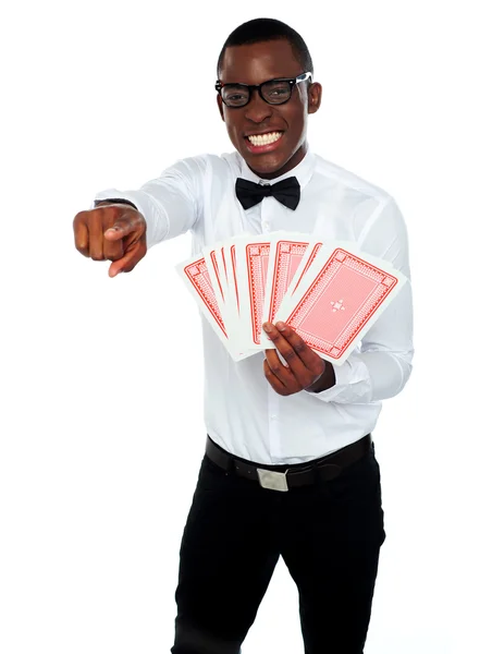 Gambler with playing cards pointing at you — Stock Photo, Image