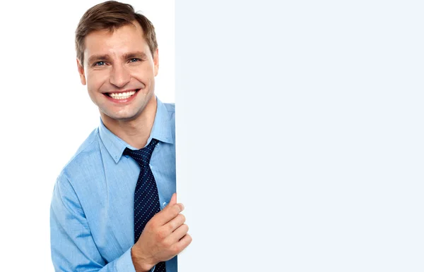Business man holding a long blank banner ad — Stock Photo, Image