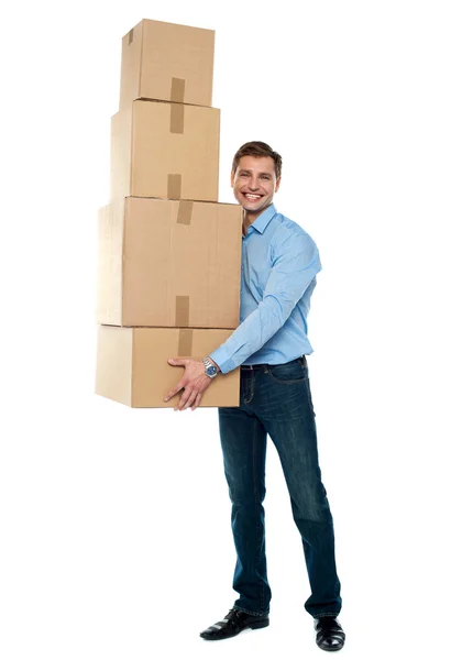 Young man with stack of cartons — Stock Photo, Image