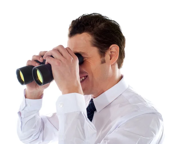 Male executive looking through binoculars — Stock Photo, Image
