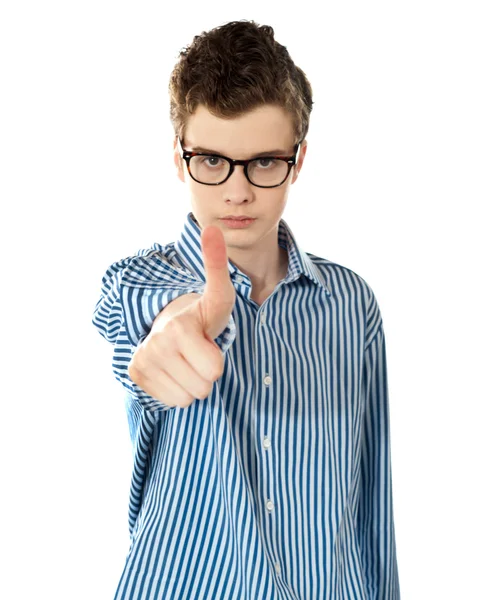 Serious boy gesturing thumbs up — Stock Photo, Image