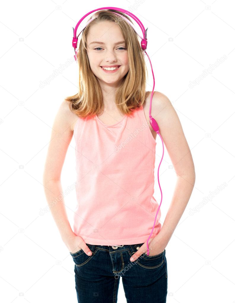 Pretty girl enjoying music through headphones