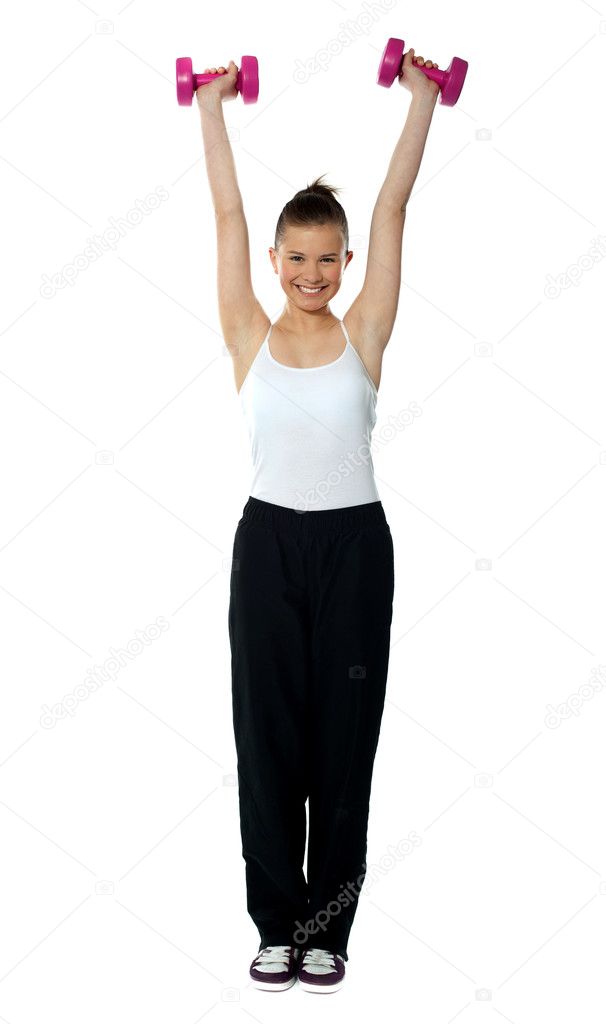 Young girl exercising with dumbbells