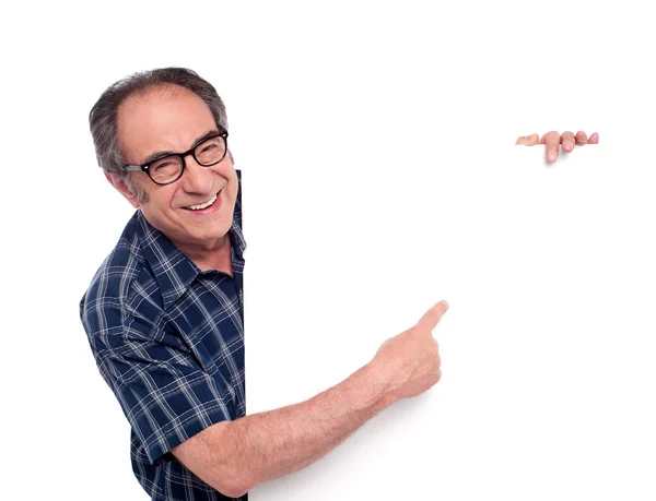 Man pointing at white blank poster — Stock Photo, Image