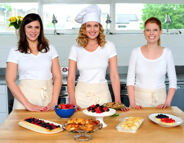 Team of confident chefs presenting snacks — Stock Photo, Image