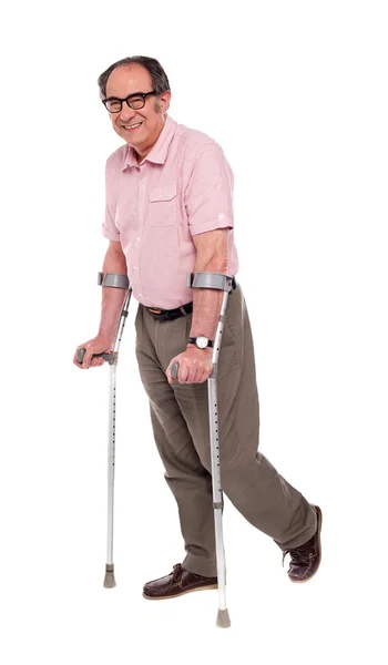 松葉杖を持つ高齢者の男の笑みを浮かべてください。 — ストック写真