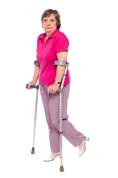 Unhappy handicapped woman with crutches — Stock Photo, Image
