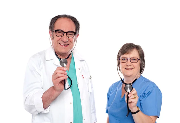 Smiling aged male and female doctors — Stock Photo, Image