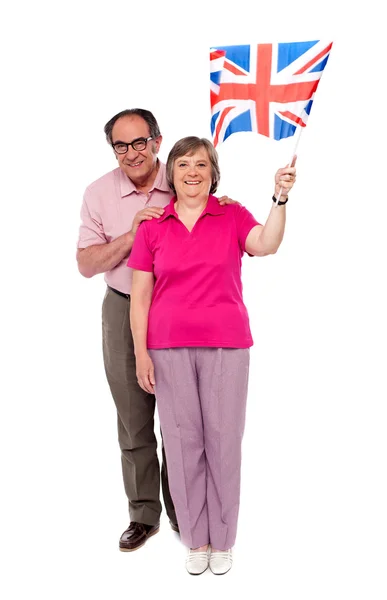 Old couple waving UK flag. Supporting nation — Stock Photo, Image