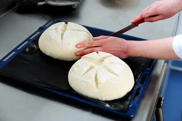 Female cutting dough in a creative manner — Stock Photo, Image