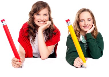 Beautiful schoolgirls posing with big pencil clipart