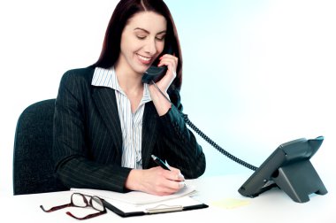 Smiling female operator attending clients call clipart