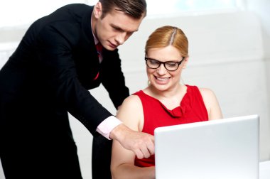 Business team in action. Man pointing at laptop clipart