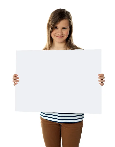 Smiling teenager showing blank white billboard — Stock Photo, Image