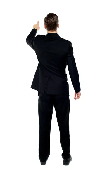 Rear view of a male model pointing — Stock Photo, Image