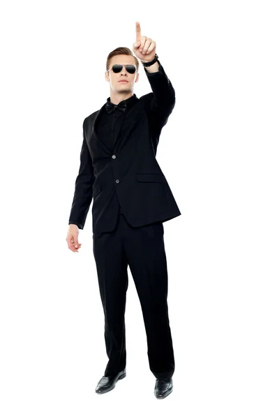 Young handsome man pointing upwards — Stock Photo, Image