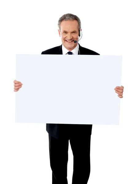 Help desk executive showing white billboard — Stock Photo, Image