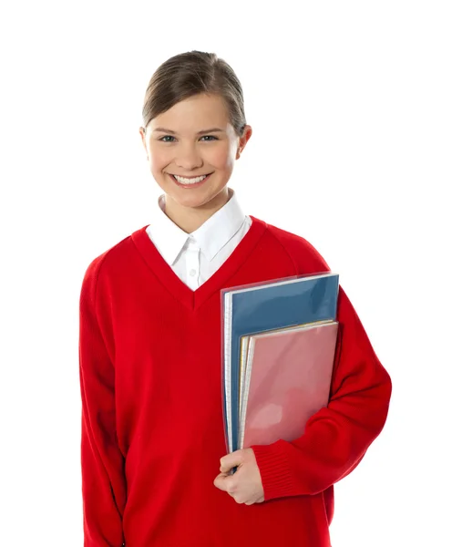 Веселая школьница с книгами в руках — стоковое фото