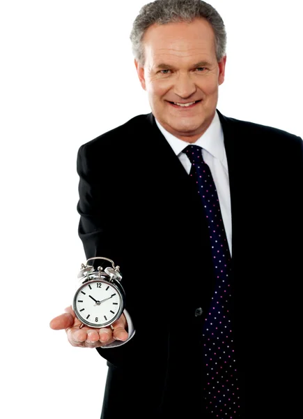 Corporate man showing alarm clock — Stock Photo, Image