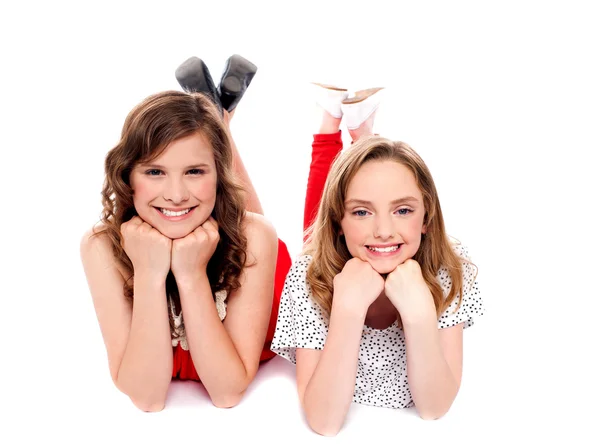 Girls posing with hands on chin. Lying on floor — Stock Photo, Image
