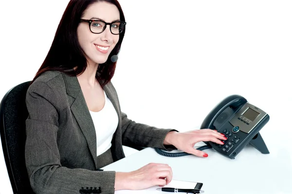 Attractive female executive dialing clients number — Stock Photo, Image