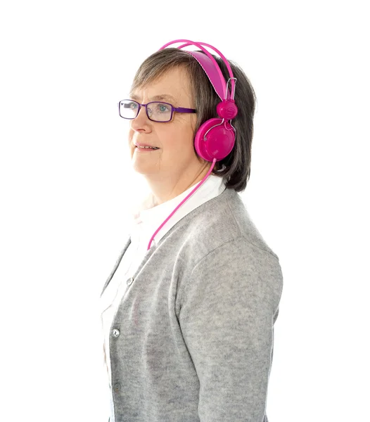 Aged female listening to music — Stock Photo, Image