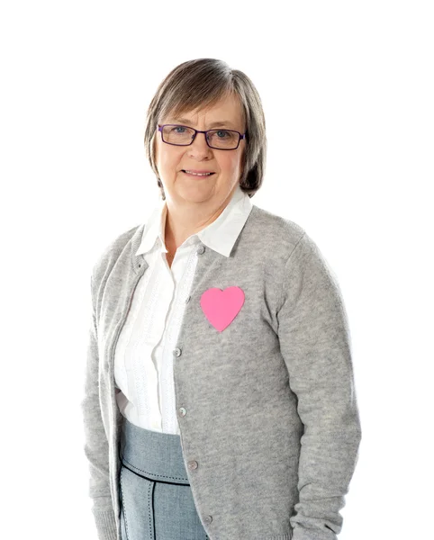 Woman with pink paper heart on her jacket — Stock Photo, Image