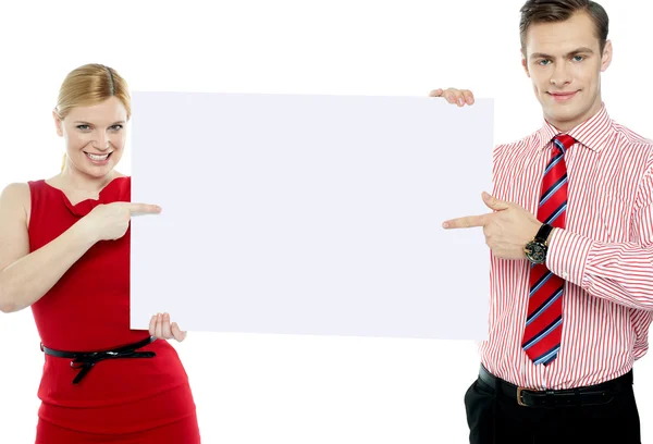 Business colleagues pointing at blank signboard — Stock Photo, Image