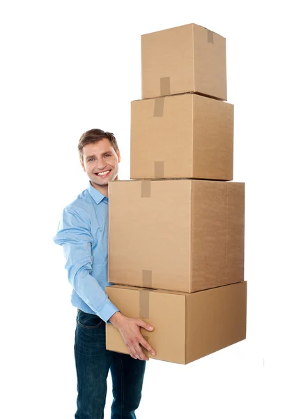 Pohledný muž s s hromadou krabic — Stock fotografie