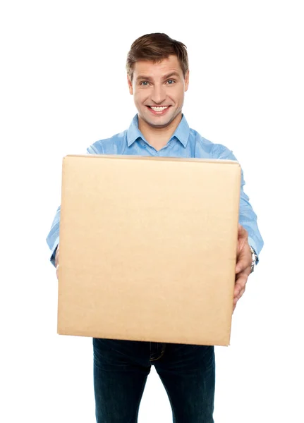 Charming handsome male holding carton — Stock Photo, Image