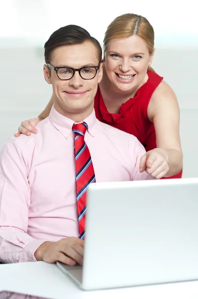 Corporate couple enjoying videos on laptop — Stock Photo, Image