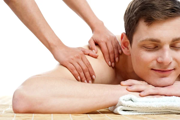 Attractive young man getting spa massage — Stock Photo, Image