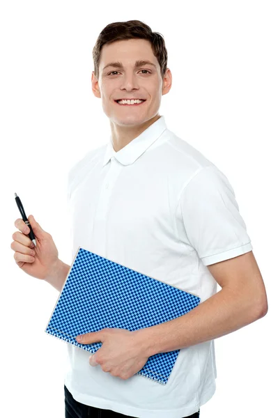 Smiling young man with notepad and pen