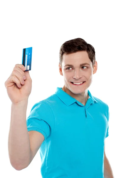 Handsome young man holding credit card — Stock Photo, Image